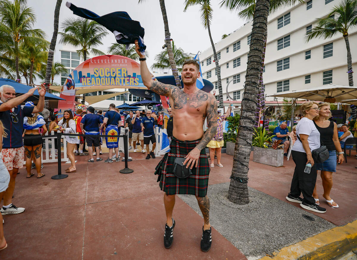 Scotland national football fan Kyle Tait jumps in front of The Clevelander as the The Tartan Army parades along Ocean Drive on Miami Beach, Tuesday, June 23, 2026.
